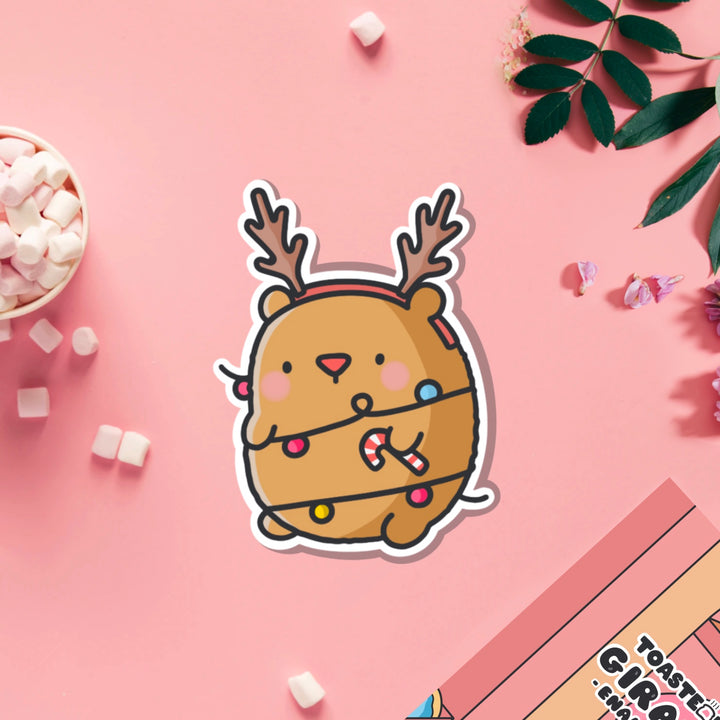 Bear as reindeer vinyl sticker on pink table