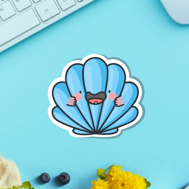 sea shell vinyl sticker on blue table with keyboard