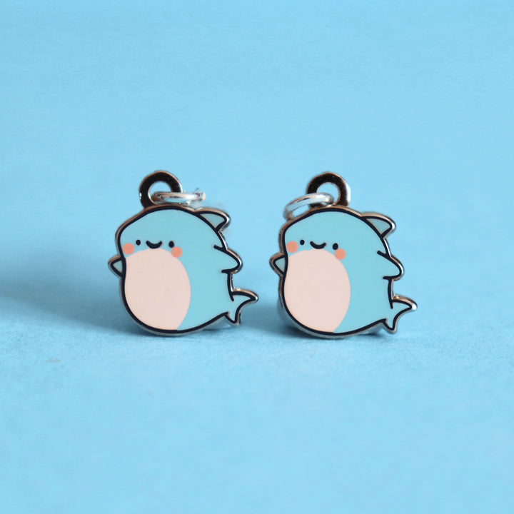 Shark earrings on blue table