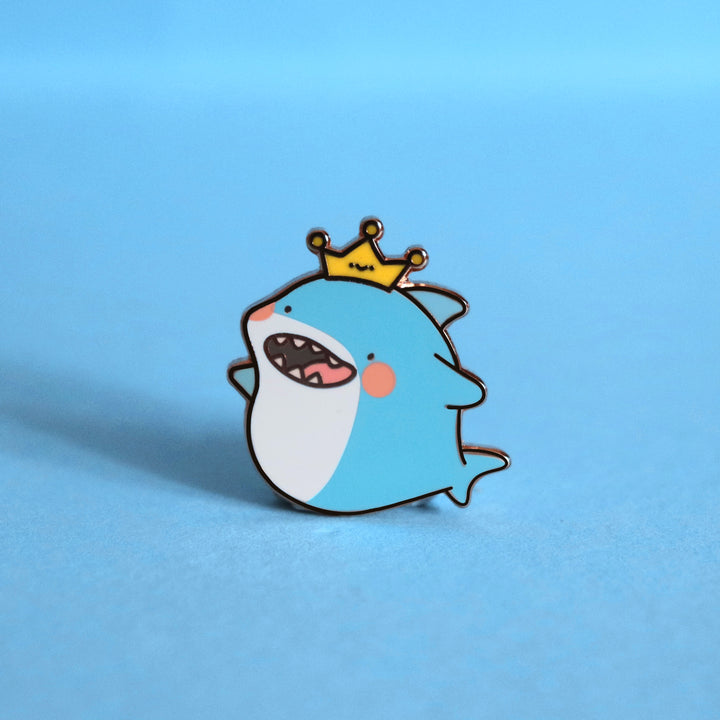 Shark enamel pin on blue background