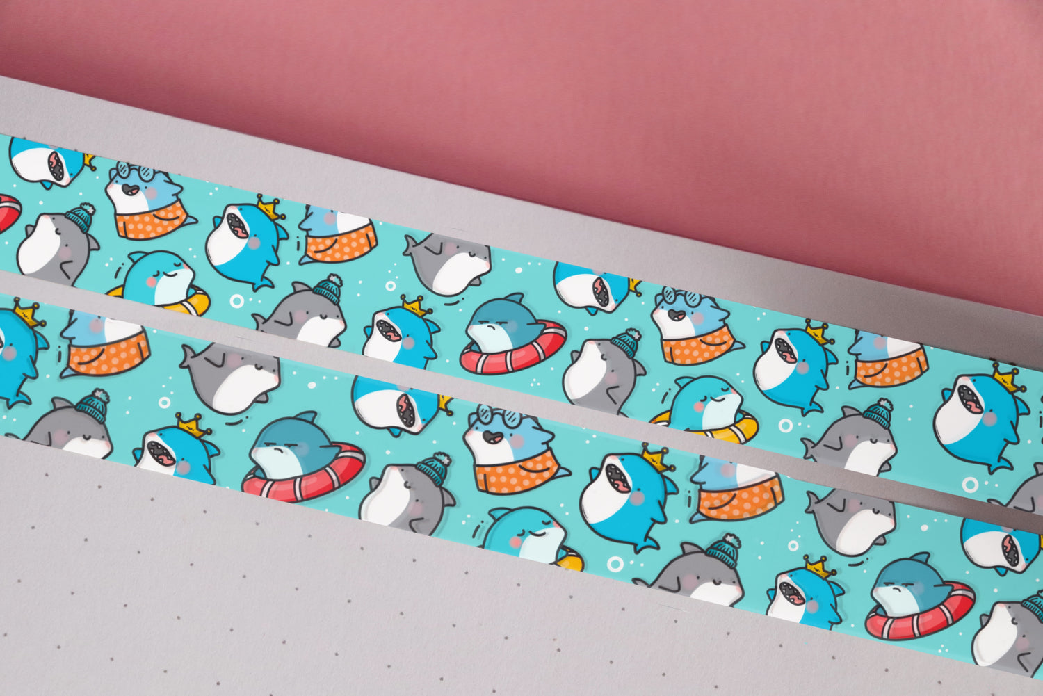 Blue shark print washi tape on notebook and pink table