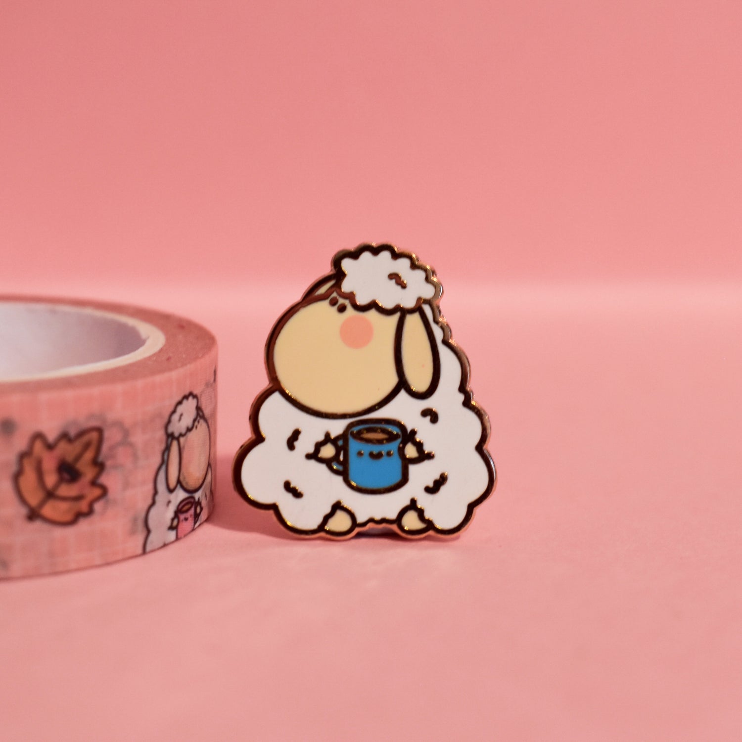 Sheep enamel pin on pink table