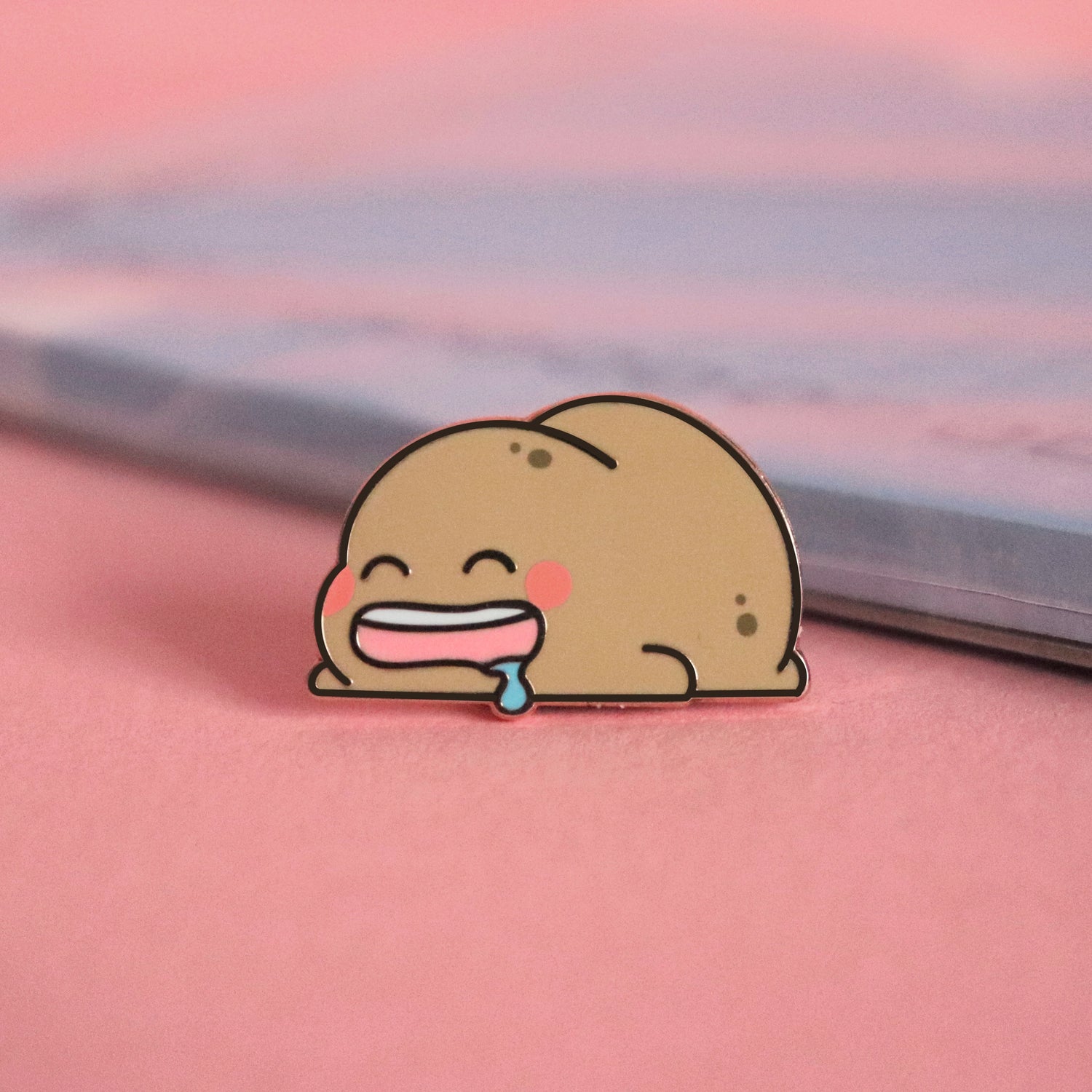 Sleeping Potato Pin on pink table with notepad