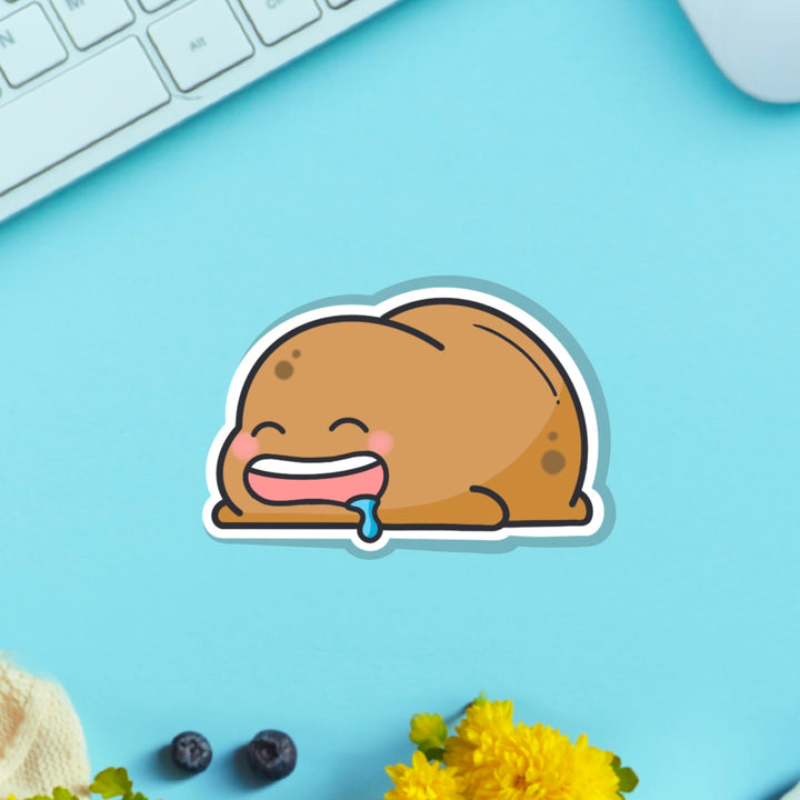 sleeping potato vinyl sticker on table with keyboard