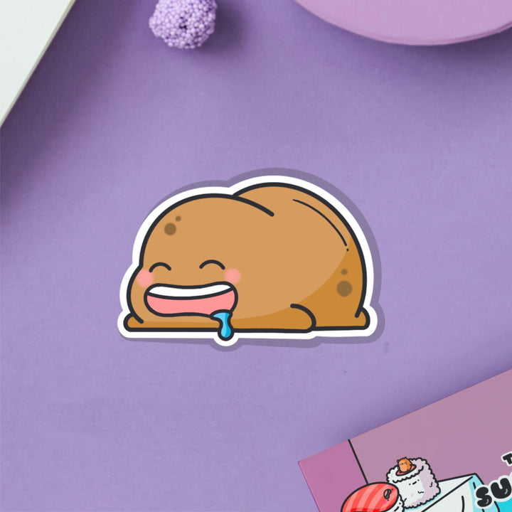 sleeping potato vinyl sticker on purple table