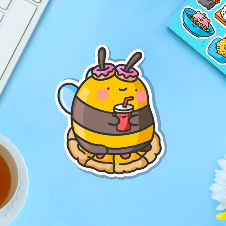 Snacking bee vinyl sticker on blue table