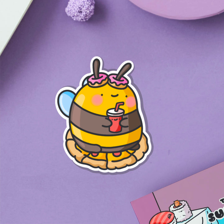 Snacking bee vinyl sticker on purple table