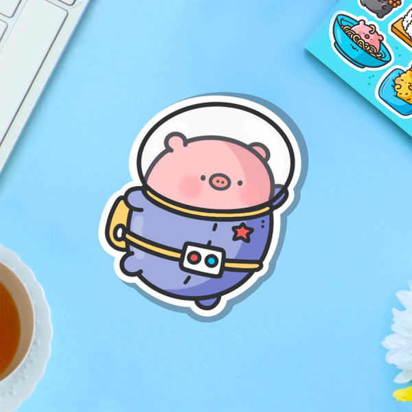 Space Pig Vinyl Sticker on blue table