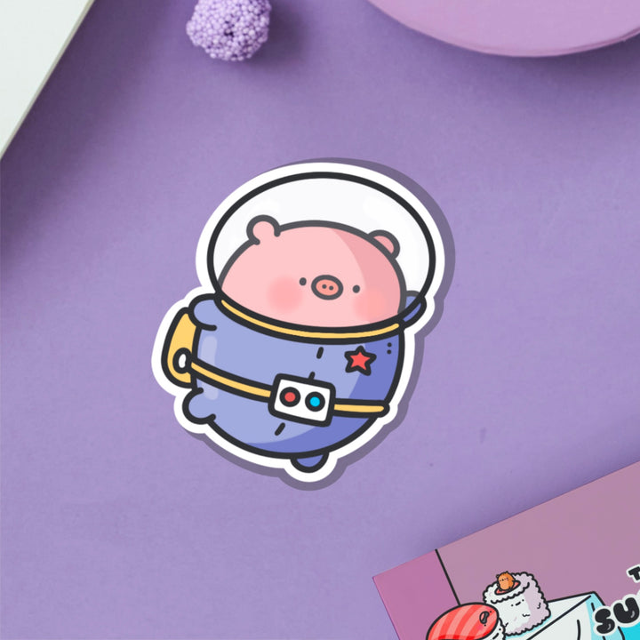 Space Pig Vinyl Sticker on purple table