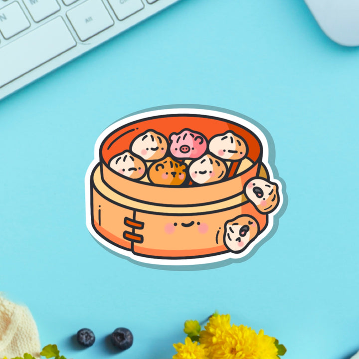 Steamed buns vinyl sticker on blue table with keyboard