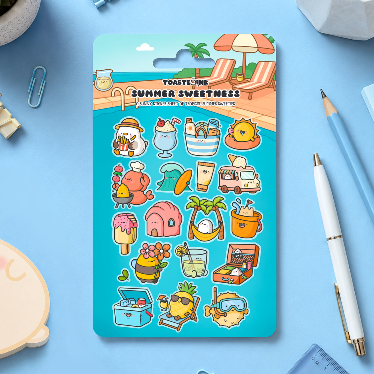 Summer sticker sheet on table with stationery scattered around