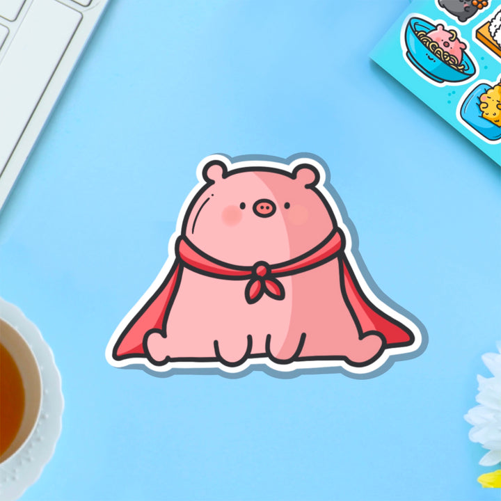 Super pig in red cape vinyl sticker on blue table