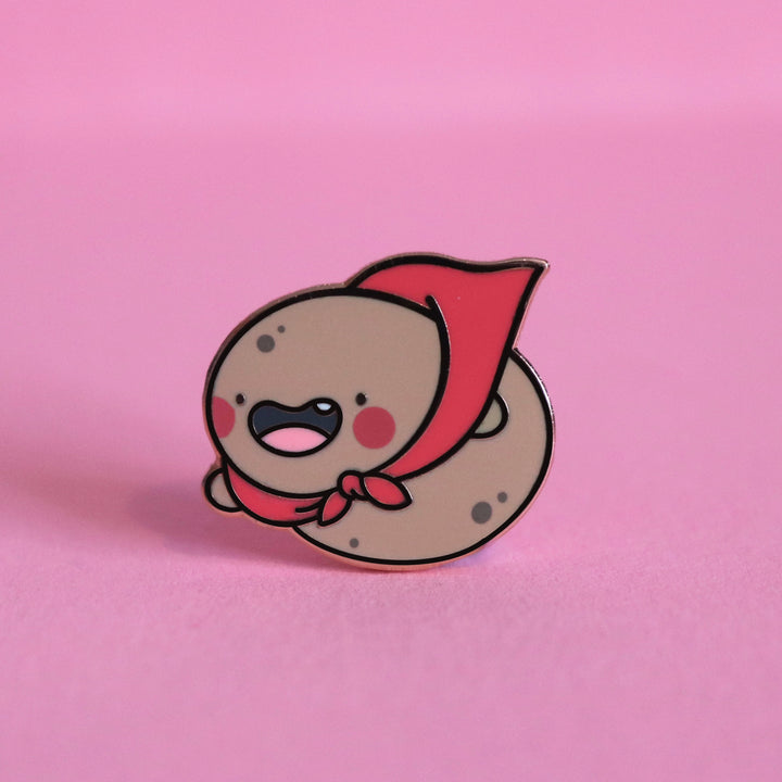 Super Potato enamel pin on pink background