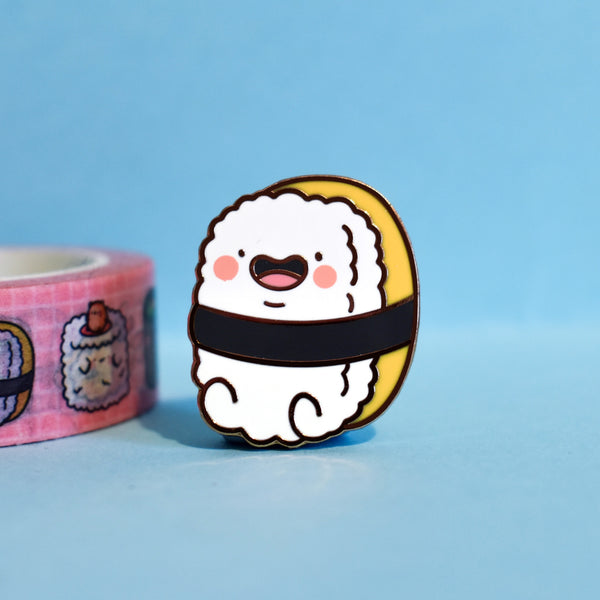 Sushi enamel pin on blue table