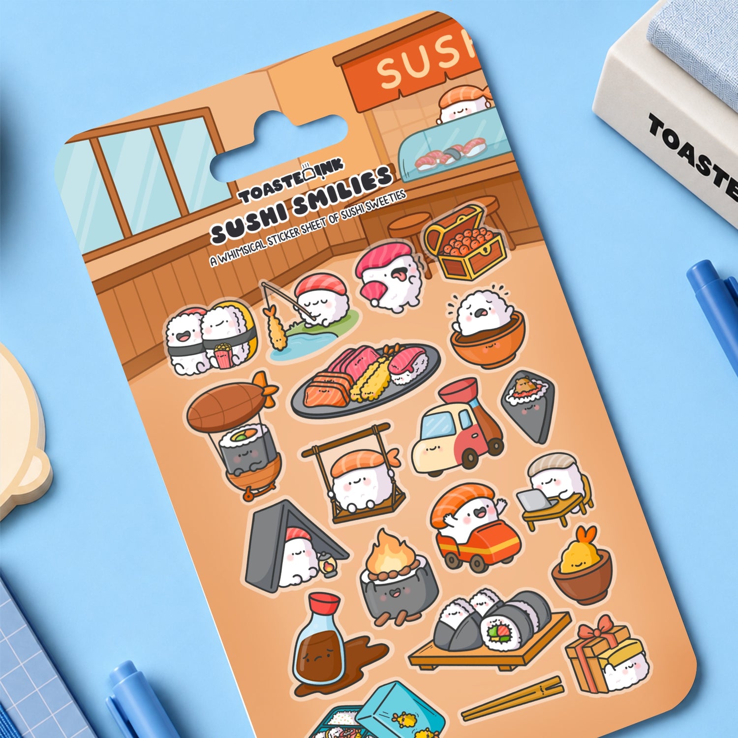 Sushi sticker sheet on blue table with stationery