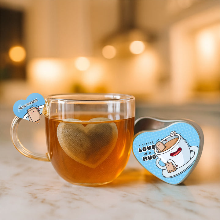 Clear mug with heart-shaped tea bag and heart shaped tin