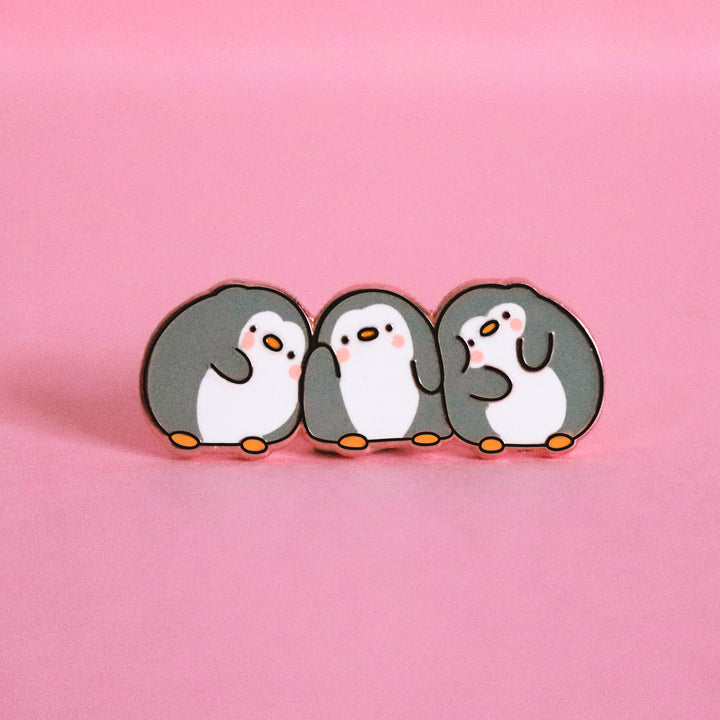 Three penguins enamel pin on pink table