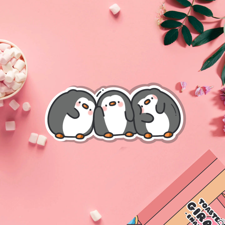 Three penguins vinyl sticker on pink table