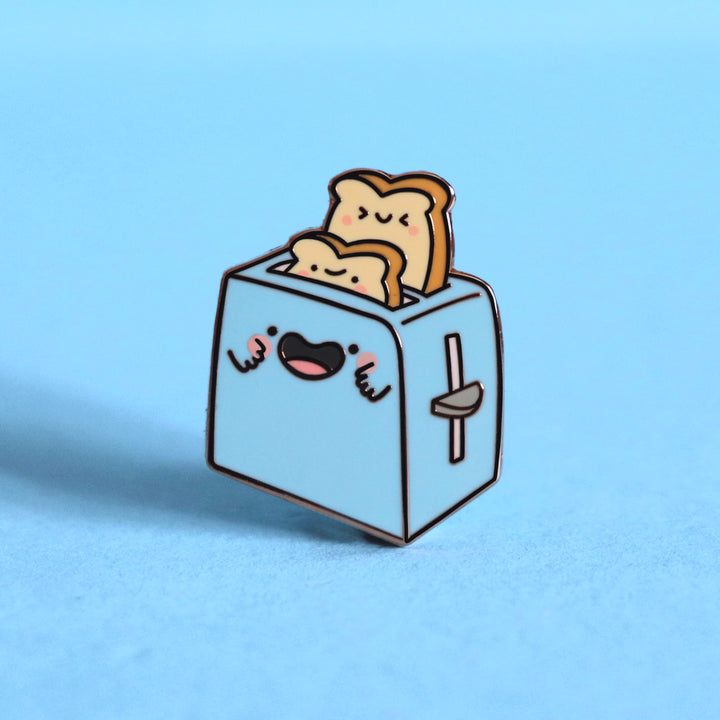 Toaster enamel pin on blue desk