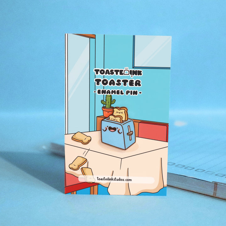 Toaster enamel pin on dining table backing card