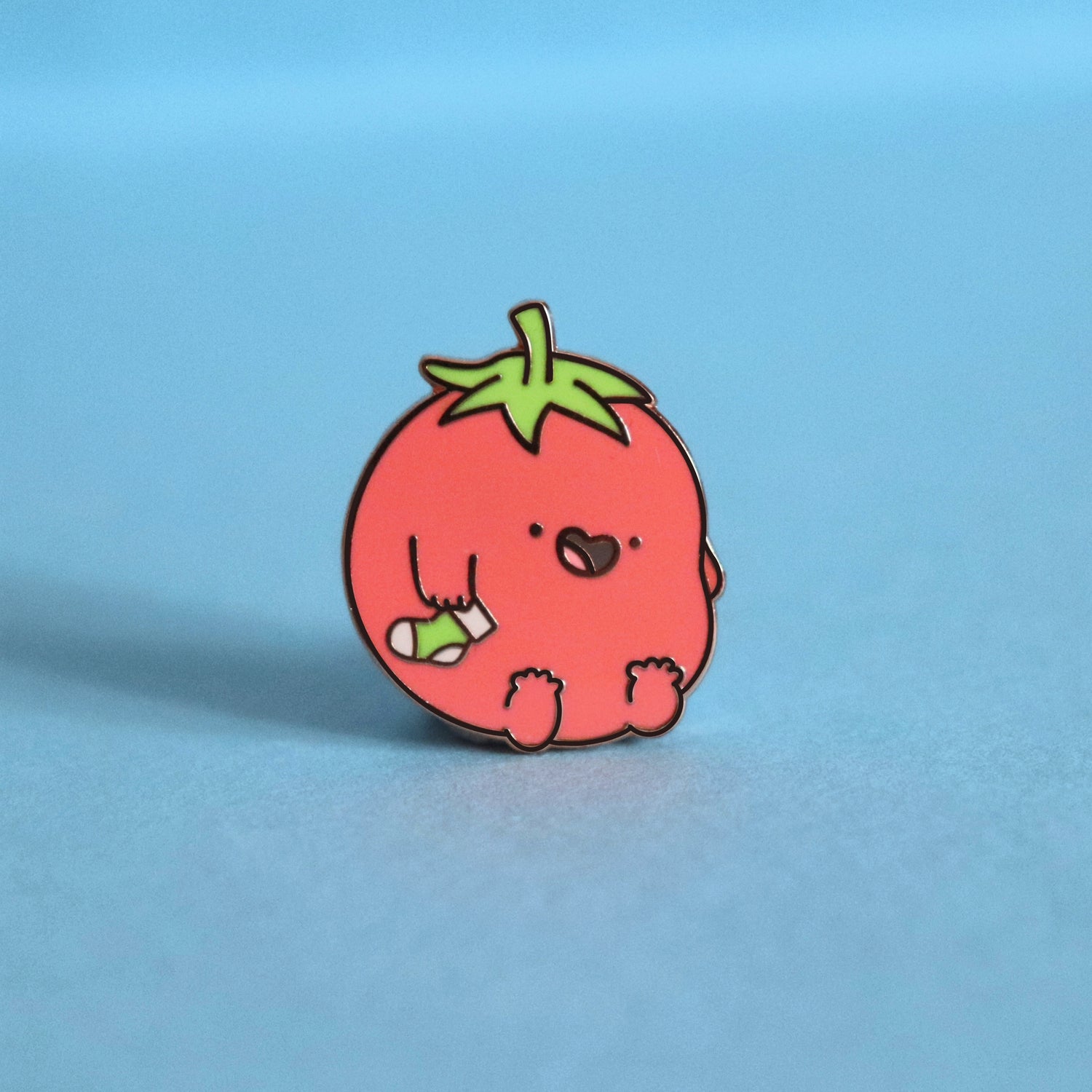 Tomatoes enamel pin on blue table