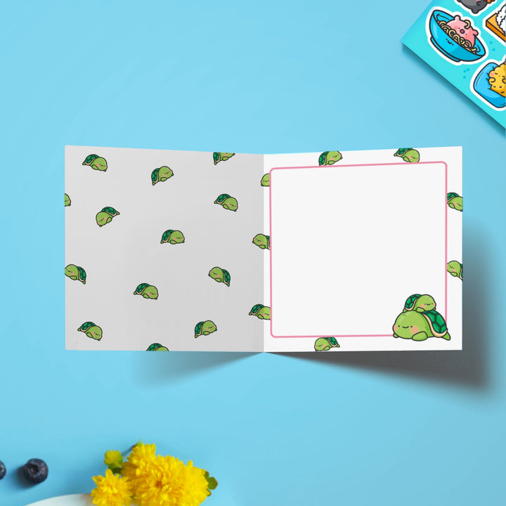 Turtle print inside card on blue table