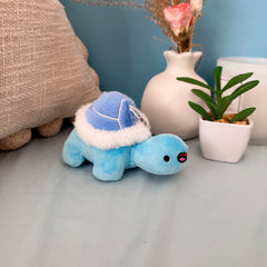 Blue turtle keychain plush with cushion and flowers