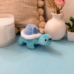 Turtle plush keyring with flowers and candle