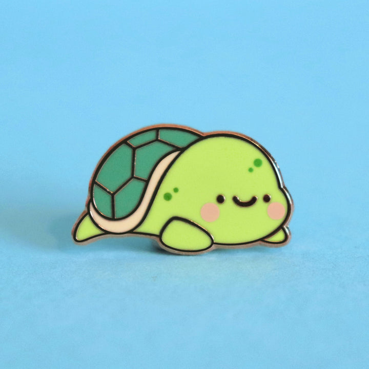 Turtle enamel pin on blue desk