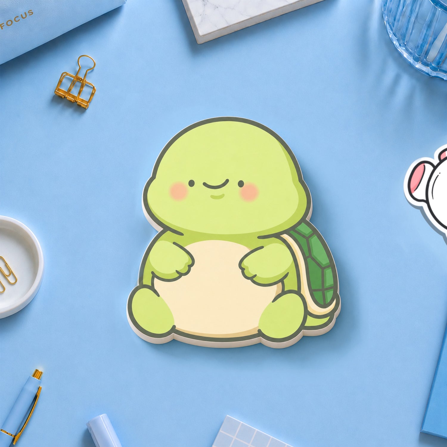 Turtle shaped sticky notes on blue table with stationery 