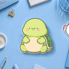 Turtle shaped sticky notes on blue table with stationery 