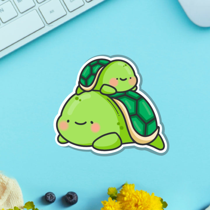 Turtle vinyl sticker on blue table with keyboard