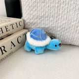 Turtle plush keychain on white table with cushion