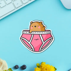 Bear in underwear vinyl sticker on blue table with keyboard