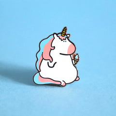 Unicorn enamel pin on blue background