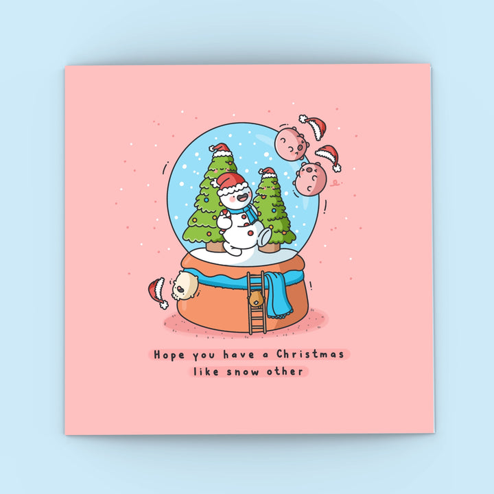 Christmas snowglobe card on blue background