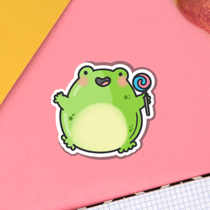 Jumping frog vinyl sticker on pink desk