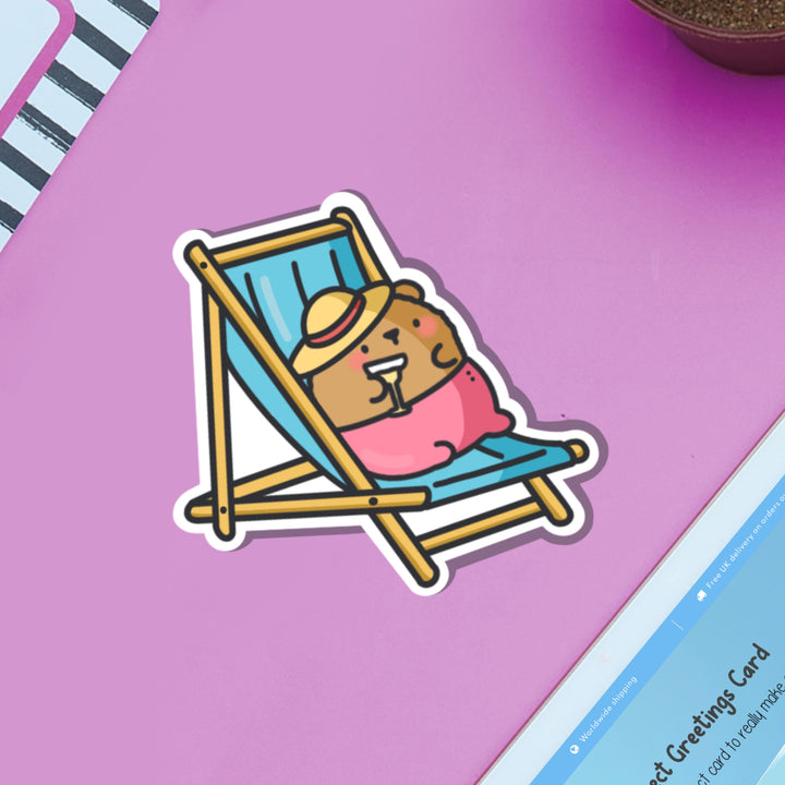 Bear Sunbathing vinyl sticker on pink background and ipad