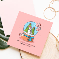 Christmas snowglobe card on wood