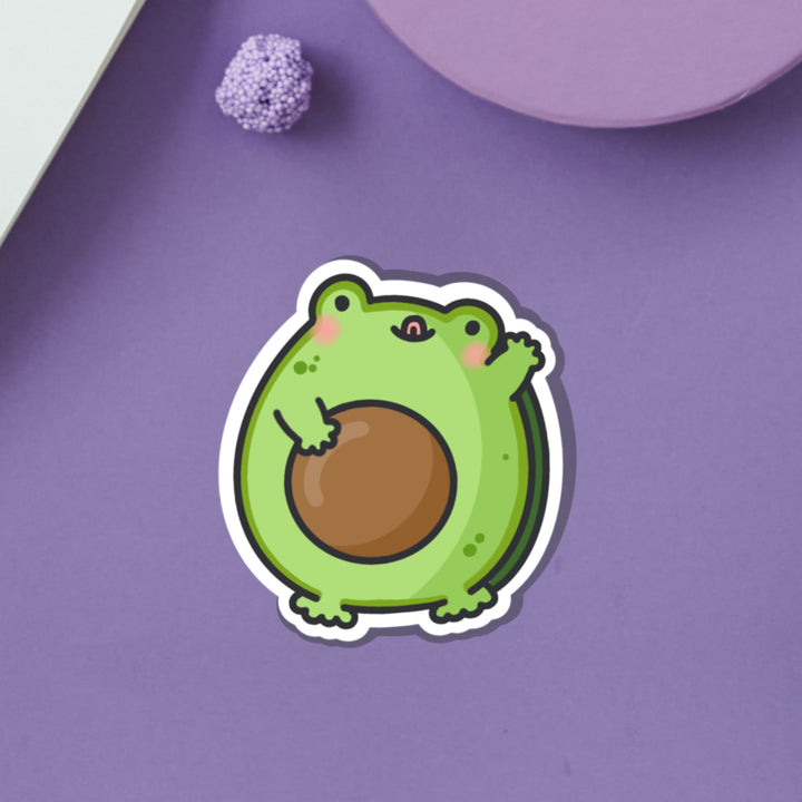 Frog as avocado vinyl sticker on purple desk