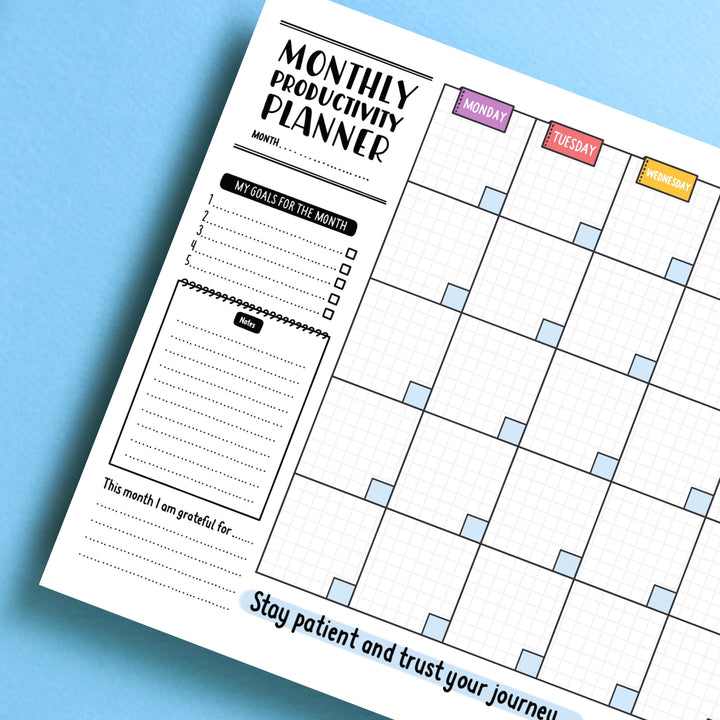 Monthly planner corner pad on blue table