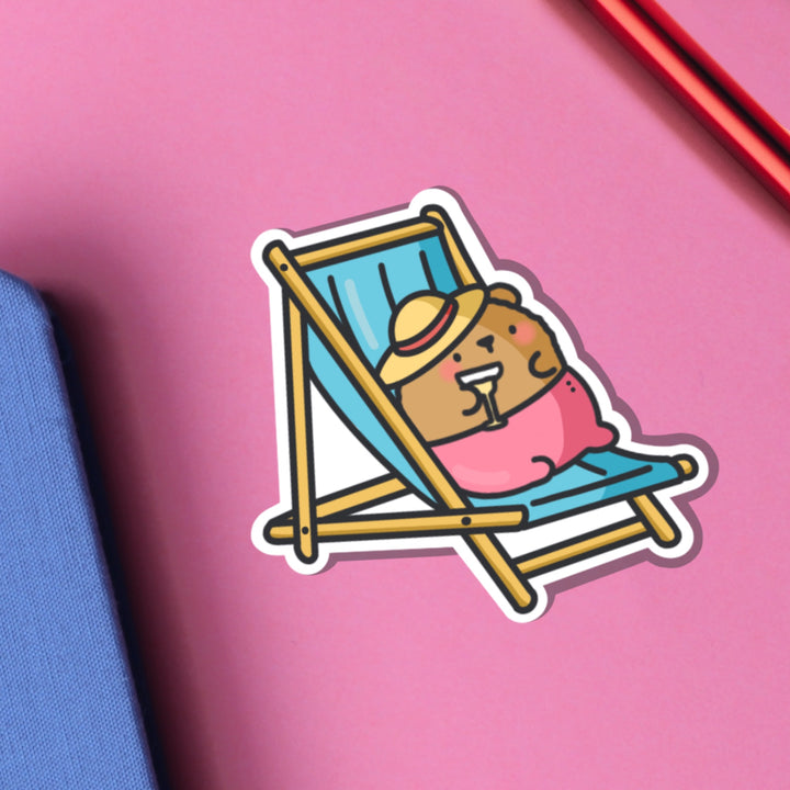 Bear Sunbathing vinyl sticker on pink table 