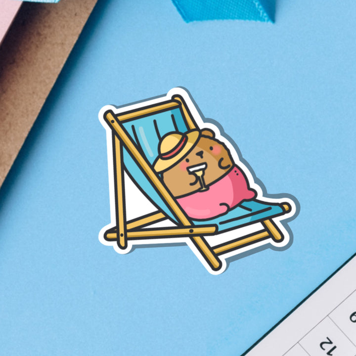 Bear Sunbathing vinyl sticker on blue background