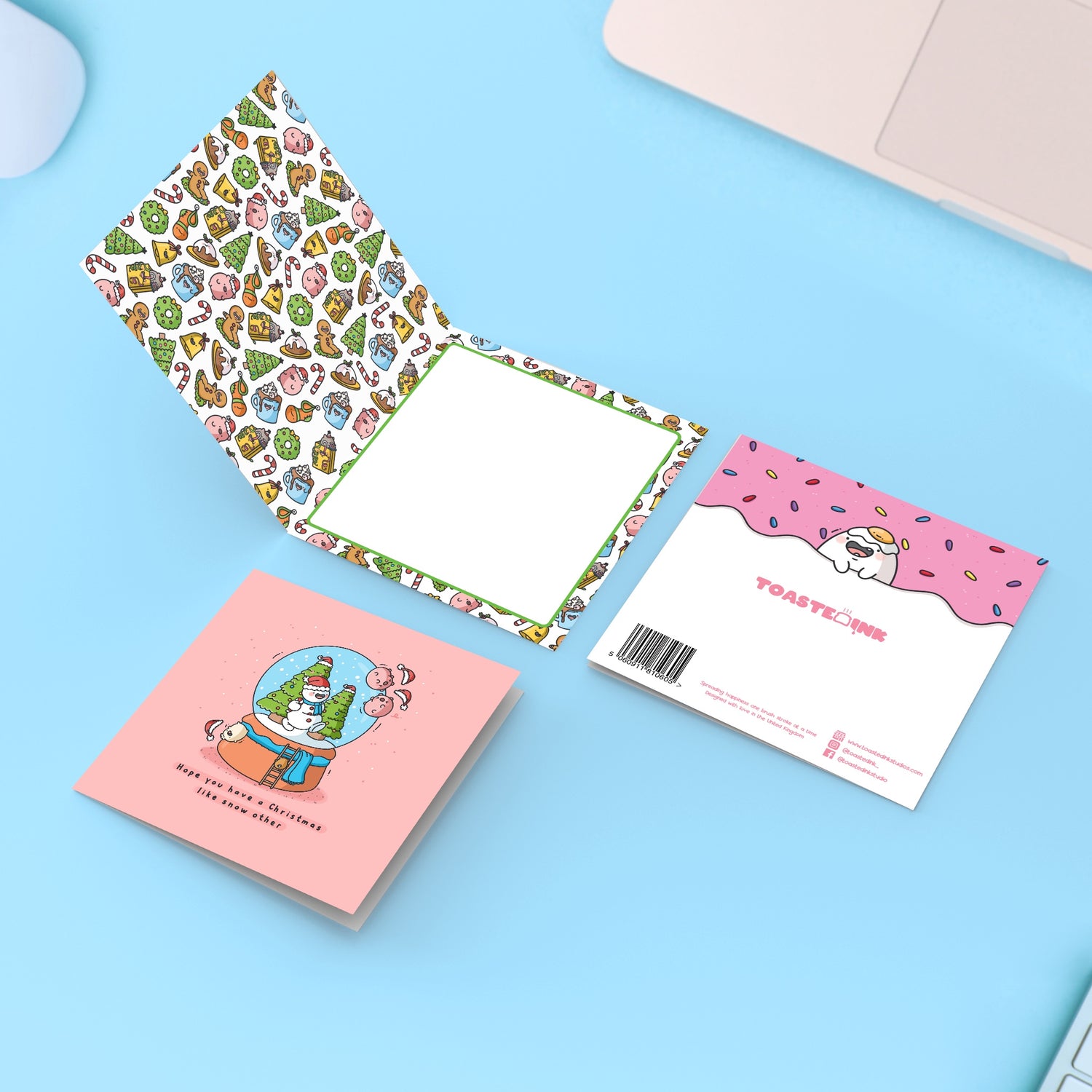 Christmas snowglobe card on blue table