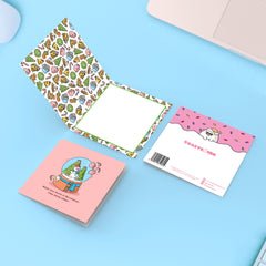 Christmas snowglobe card on blue table