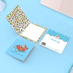 Santa Dogs Christmas card on blue table