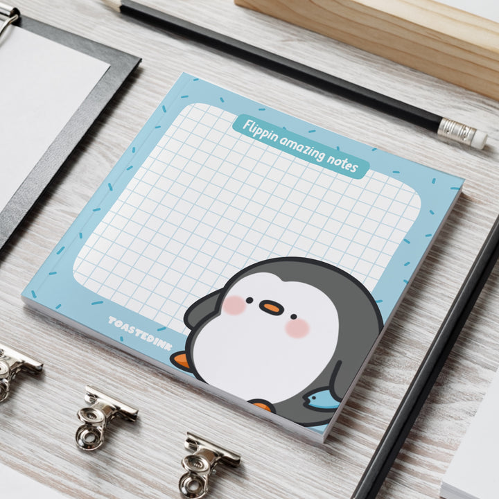 Penguin sticky notes on grey table