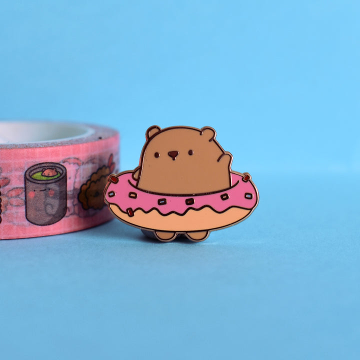 Cute donut bear enamel pin on blue background