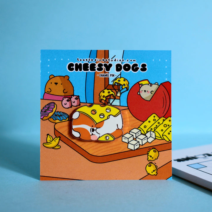 Cheese dog enamel pin on cheese backing card blue table