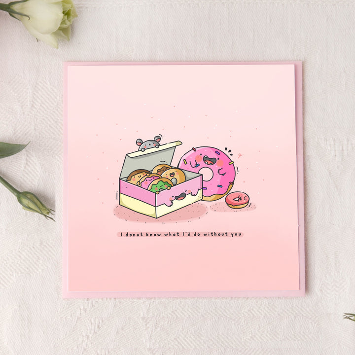 Cute donuts card on pink table